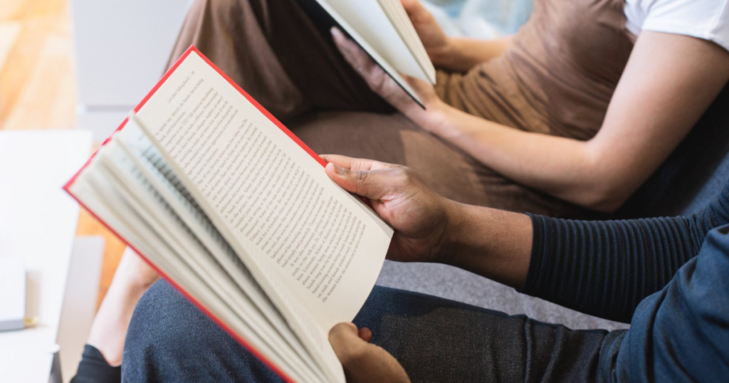 two people with books open on their laps - discover your child's autism behavioural profile